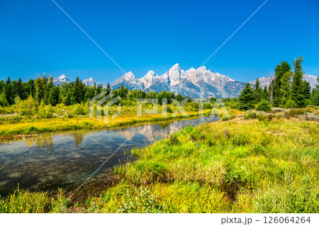 Breathtaking view of the Grand Teton Mountain Range reflecting in the calm waters of the Snake River, captured in Wyoming, United States 126064264
