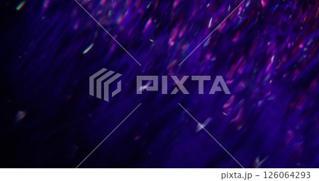 Light flare. Defocused rainbow reflection. Purple color blinking sparkling lens liquid motion on blurred bokeh abstract modern background. Light flare. Defocused rainbow reflection. Purple color blinking sparkling lens liquid motion on blurred bokeh abstract modern background. 126064293