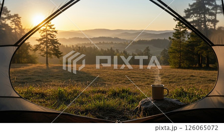 Tent view reveals serene sunrise over misty hills. Coffee steams. Serene start 126065072