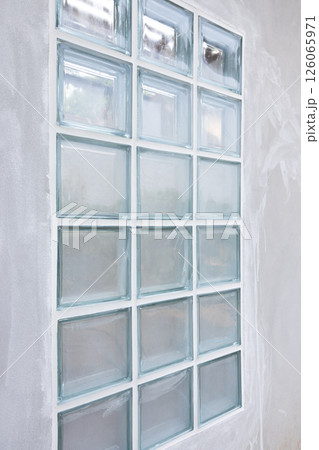 Clear glass block and concrete wall. 126065971