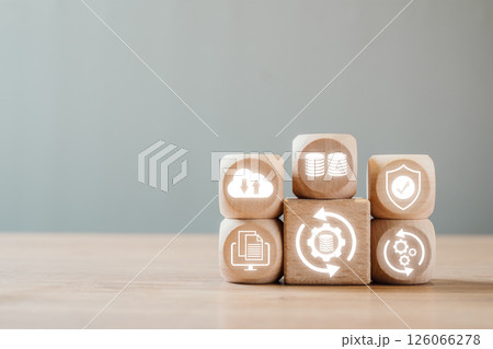 Wooden blocks with icons representing data backup, cloud storage, and security on a wooden surface. Wooden blocks with icons representing data backup, cloud storage, and security on a wooden surface. 126066278
