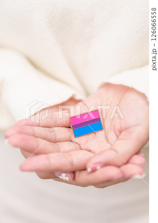 Bisexuality Celebrate Day and LGBT pride month, LGBTQ or LGBTQIA concept. Hand holding purple, pink and blue flag shape for Lesbian, Gay, Bisexual, Transgender, Queer, Pansexual, Marriage Equality Law Bisexuality Celebrate Day and LGBT pride month, LGBTQ or LGBTQIA concept. Hand holding purple, pink and blue flag shape for Lesbian, Gay, Bisexual, Transgender, Queer, Pansexual, Marriage Equality Law 126066558