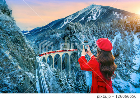 Tourist visiting Landwasser Viaduct world heritage in Swiss Alps snow winter scenery, Switzerland. 126066656