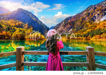 Tourist take a photo at Jiuzhaigou national park in autumn, China. 126066666