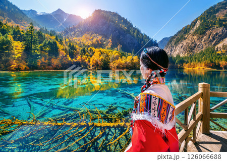 Tourist wearing traditional clothes at jiuzhaigou national park in autumn, Sichuan, China. 126066688