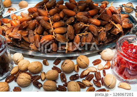 Various nuts and dried fruits in health food store display case. Various nuts and dried fruits in health food store display case. 126067201