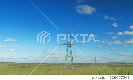 A Beautiful Electric Transmission Tower Standing Proudly Under a Clear Blue Sky Above Time lapse. 126067561