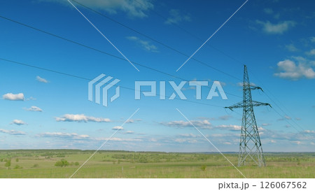 High Voltage Power Lines Stand Tall in a Beautifully Serene Landscape Amidst Natures Beauty Time lapse. 126067562