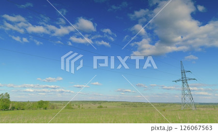 A breathtaking sunny landscape featuring a serene view of power lines against clear skies Time lapse. A breathtaking sunny landscape featuring a serene view of power lines against clear skies Time lapse. 126067563