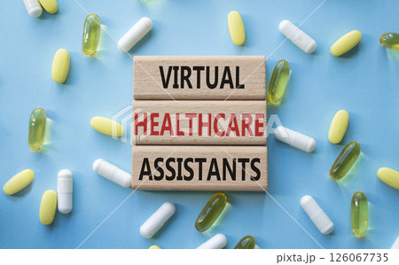 Medicine symbol. Concept words Virtual Healthcare Assistants on wooden blocks. Beautiful blue background with pills. Medicine concept and Virtual Healthcare Assistants. Copy space Medicine symbol. Concept words Virtual Healthcare Assistants on wooden blocks. Beautiful blue background with pills. Medicine concept and Virtual Healthcare Assistants. Copy space 126067735