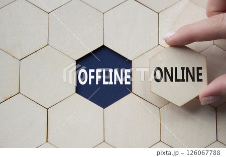 Offline or Online symbol. Concept word Offline or Online on wooden comb puzzle. Businessman hand. Beautiful deep blue background. Business and Offline or Online concept. Copy space 126067788