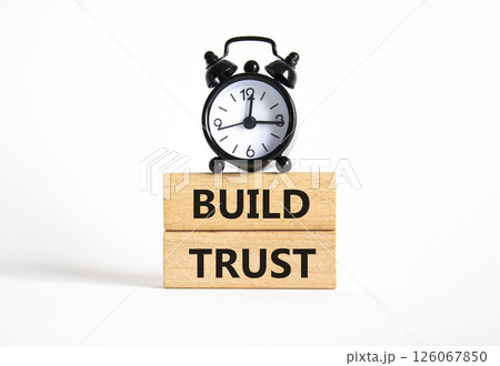 Build trust symbol. Wooden blocks with words Build trust. Beautiful white background with alarm clock. Business and Build trust concept. Copy space. 126067850