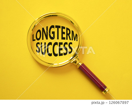 Longterm success symbol. Magnifying Glass with Concept word Longterm success. Beautiful yellow background. Business and Longterm success concept. Copy space 126067897