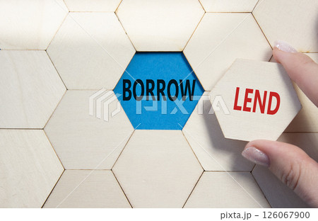 Lend or Borrow symbol. Concept word Lend or Borrow on wooden comb puzzle. Businessman hand. Beautiful blue background. Business and Lend or Borrow concept. Copy space 126067900