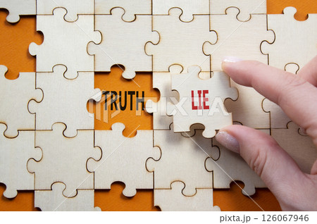 Truth or Lie symbol. Concept word Truth or Lie on wooden puzzle. Businessman hand. Beautiful orange background. Business and Truth or Lie concept. Copy space 126067946
