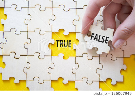 True or False symbol. Concept word True or False on wooden puzzle. Businessman hand. Beautiful yellow background. Business and True or False concept. Copy space True or False symbol. Concept word True or False on wooden puzzle. Businessman hand. Beautiful yellow background. Business and True or False concept. Copy space 126067949
