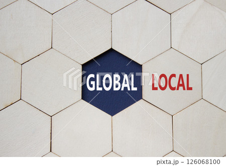 Global and Local symbol. Concept word Global and Local on wooden comb puzzle. Beautiful deep blue background. Business and Global and Local concept. Copy space Global and Local symbol. Concept word Global and Local on wooden comb puzzle. Beautiful deep blue background. Business and Global and Local concept. Copy space 126068100