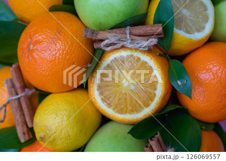 Creative layout of apples, orange, lemon, cinnamon sticks. Flat layout. The concept of food. A macro concept. 126069557