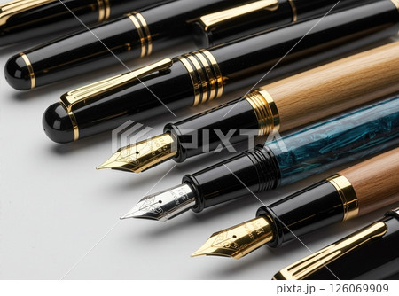 Elegant Collection of Premium Fountain Pens with Gold Nibs and Luxury Metallic Barrels on White Background Elegant Collection of Premium Fountain Pens with Gold Nibs and Luxury Metallic Barrels on White Background 126069909