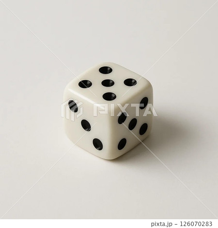 A close-up shot of a classic white dice with black dots. 126070283