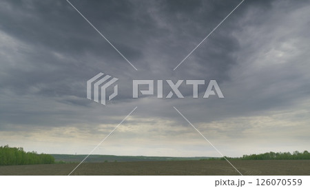 A Dramatic Cloudy Sky Over An Expansive Open Field Landscape That Captivates the Viewer A Dramatic Cloudy Sky Over An Expansive Open Field Landscape That Captivates the Viewer 126070559