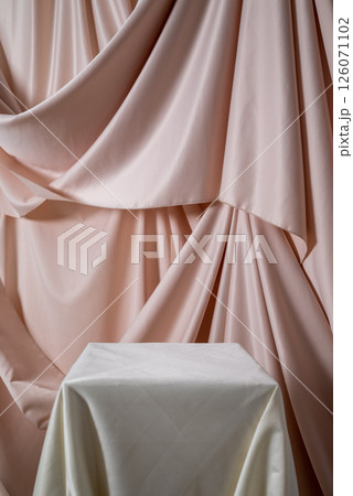 Geometric light empty podium with textile drapery on pink background, display for presentation of products, cosmetics and perfumes Geometric light empty podium with textile drapery on pink background, display for presentation of products, cosmetics and perfumes 126071102