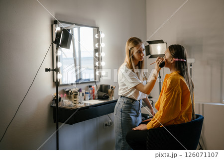 Makeup Artist Applying Foundation to Client in Salon Makeup Artist Applying Foundation to Client in Salon 126071107