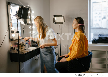 Makeup Artist Applying Foundation to Client in Salon Makeup Artist Applying Foundation to Client in Salon 126071120