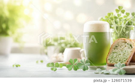 refreshing glass of green beer beside Irish soda bread and clovers, perfect for celebrations 126071539