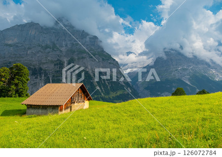 View on the alpine valley Grindelwald. Jungfrau, Switzerland. Under the Bernese alps. Mountain village. View on the alpine valley Grindelwald. Jungfrau, Switzerland. Under the Bernese alps. Mountain village. 126072784