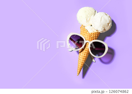 White vanilla ice cream cone and sunglasses on purple White vanilla ice cream cone and sunglasses on purple 126074862