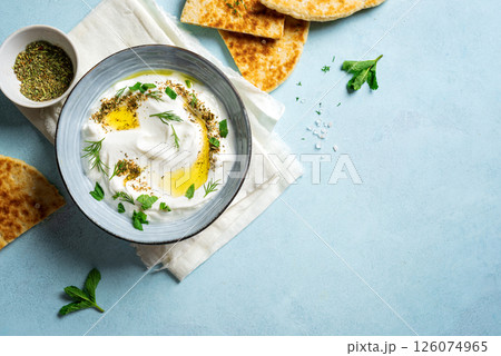 Labneh yogurt cream cheese with olive oil, herbs and zaatar 126074965