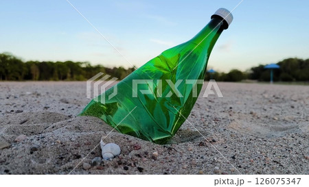 trash on the beach. An abandoned plastic bottle on the shore of a clean beach. an evening view of an empty beach, an empty plastic bottle lying on the sand like garbage. 126075347
