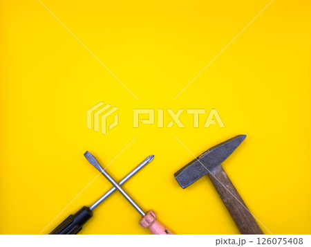 Set of various construction tools. Tools for home repair. Work at a construction site. On a yellow background. Flat lay. Top view, copy space. Set of various construction tools. Tools for home repair. Work at a construction site. On a yellow background. Flat lay. Top view, copy space. 126075408