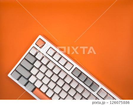 A top view of office flat lays, keyboard without letters on an empty yellow-orange space on a background, for business and technology concept. Copy space. 126075886