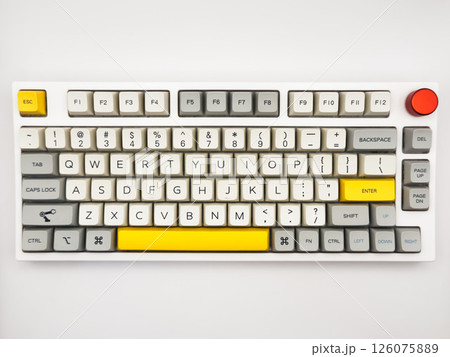 White Keyboard with an accented yellow Space button and red button for remote work. Top view with white background White Keyboard with an accented yellow Space button and red button for remote work. Top view with white background 126075889
