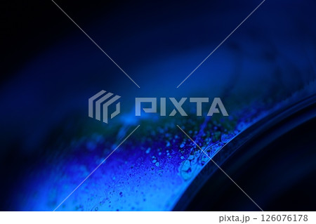 Deep blue liquid surface on black background, oil stains movement, bright chemistry, surreal background, blue sky colour, flat panels 126076178