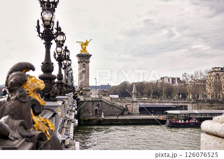 Detail of ornate bridge architecture with golden statue.Paris France 04.01.2025 126076525