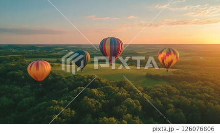 colorful hot air balloons rising over green fields 126076806