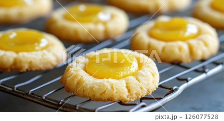 National Lemon Bar Day Lemon curd thumbprint cookies on cooling rack: freshly baked treats 126077528