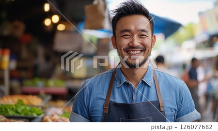 Portrait of a smiling vendor in an outdoor market setting 126077682