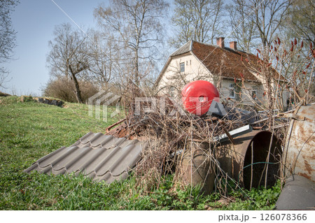 Pile of Scrap Metal and Old Materials in Front of Rural House Pile of Scrap Metal and Old Materials in Front of Rural House 126078366