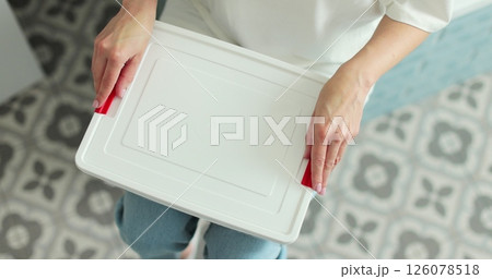Woman open the first aid kit at home. First aid kit. Woman open the first aid kit at home. First aid kit. 126078518