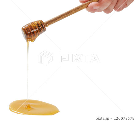 wooden honey dipper with golden honey dripping wooden honey dipper with golden honey dripping 126078579
