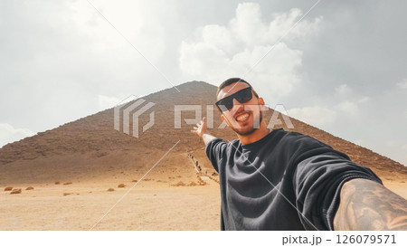 Tourist showing the red pyramid of dahshur, egypt Tourist showing the red pyramid of dahshur, egypt 126079571