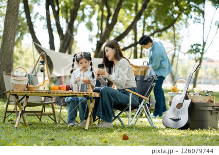 Happy asian family picnic in park, weekend lifestyle outdoors. Happy asian family picnic in park, weekend lifestyle outdoors. 126079744