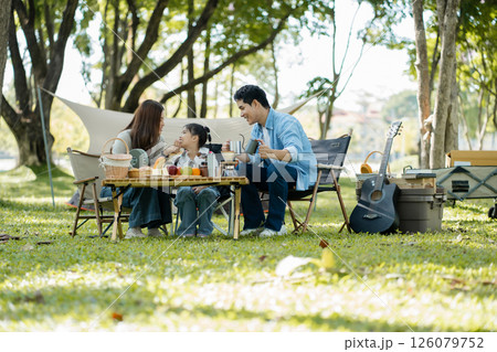 Happy asian family picnic in park, weekend lifestyle outdoors. Happy asian family picnic in park, weekend lifestyle outdoors. 126079752
