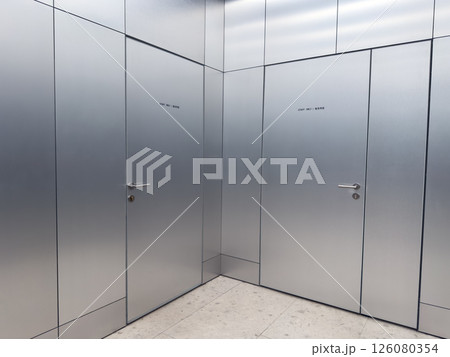 Metal doors with staff only signs in a modern public facility. Clean corridor with minimalistic design and restricted access area. Concept of security, maintenance and controlled entry Metal doors with staff only signs in a modern public facility. Clean corridor with minimalistic design and restricted access area. Concept of security, maintenance and controlled entry 126080354