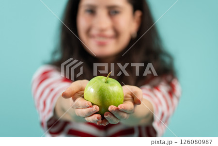 Close-up of woman holding green apple 126080987