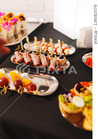 Assorted canapes on metal trays. Delicious appetizers for a buffet.  126082579
